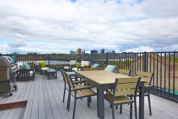 wooden terrace featuring outdoor dining area and an outdoor living space