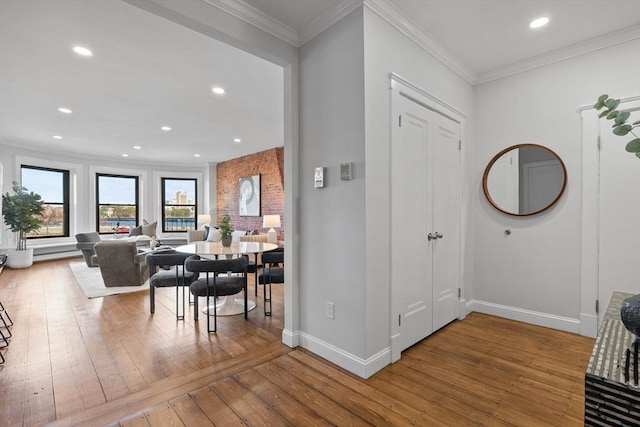 entrance foyer featuring baseboards, hardwood / wood-style floors, recessed lighting, and crown molding