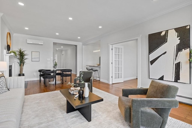 living area with ornamental molding, a wall unit AC, and wood finished floors