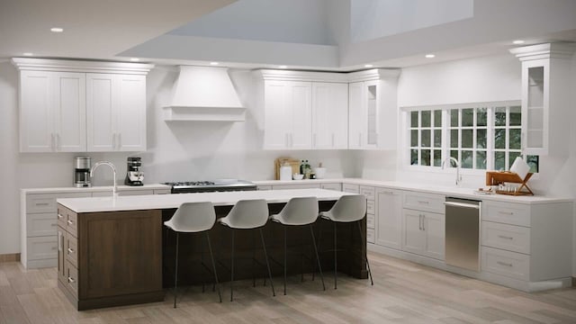 kitchen featuring a kitchen island with sink, light hardwood / wood-style flooring, white cabinets, and custom exhaust hood