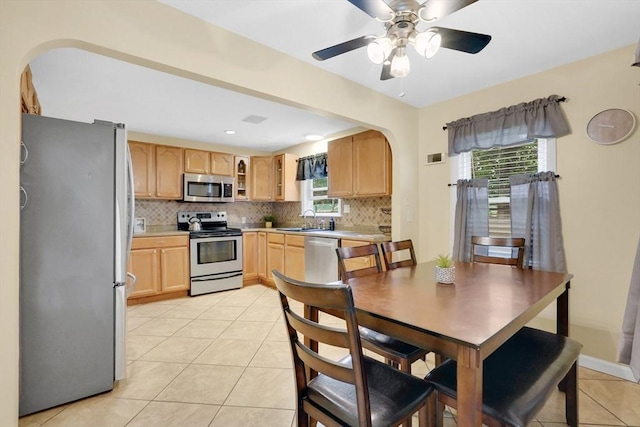 122 Brookside Cir, Springfield, MA 01129 - dining area featuring arched walkways, light tile patterned floors, and a ceiling fan