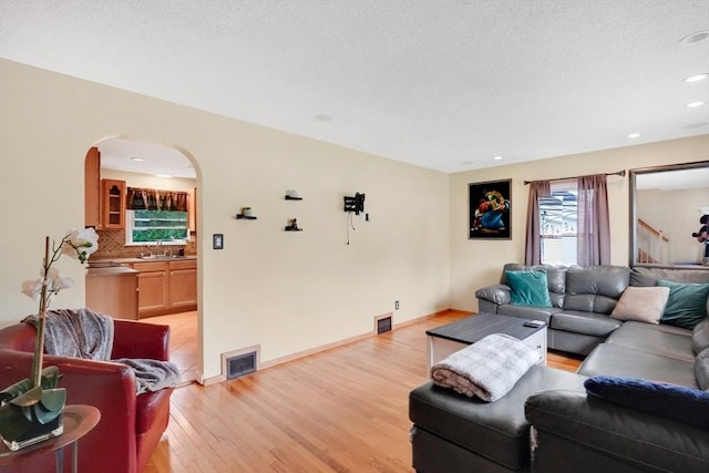 122 Brookside Cir, Springfield, MA 01129 - living room featuring arched walkways, light wood-style flooring, and recessed lighting