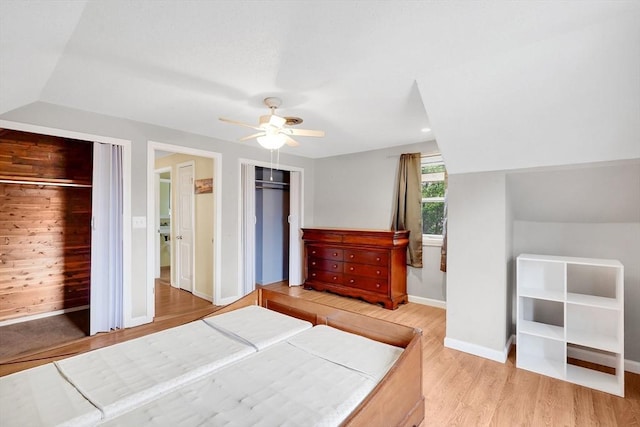122 Brookside Cir, Springfield, MA 01129 - bedroom with multiple closets, light wood-type flooring, a ceiling fan, and vaulted ceiling