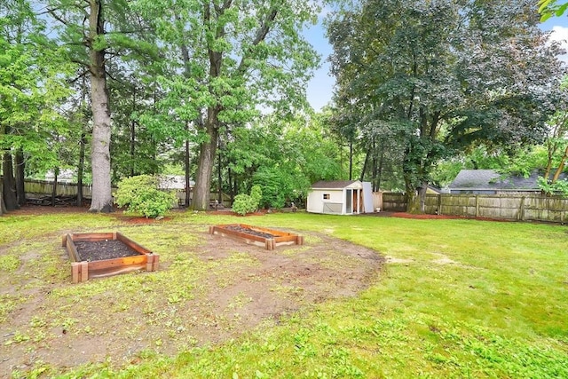 122 Brookside Cir, Springfield, MA 01129 - fenced backyard with a garden, a shed, and view of wooded area