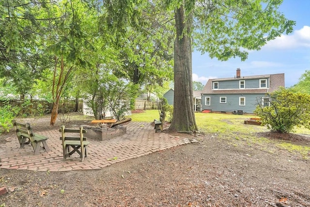 122 Brookside Cir, Springfield, MA 01129 - fenced backyard featuring a patio and a fire pit