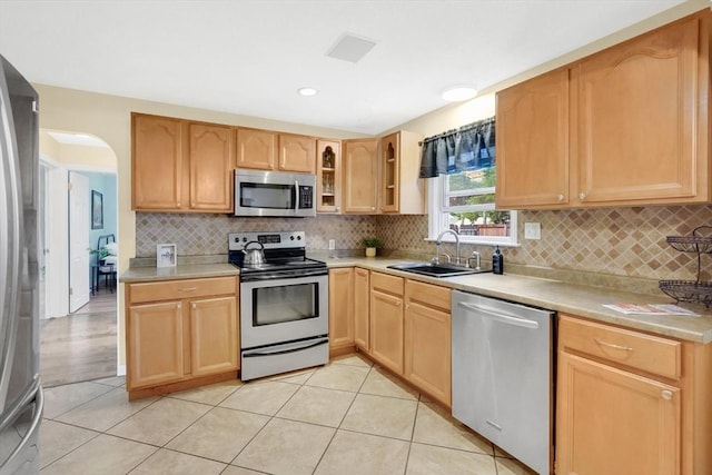122 Brookside Cir, Springfield, MA 01129 - kitchen with appliances with stainless steel finishes, light brown cabinetry, glass insert cabinets, light countertops, and tasteful backsplash
