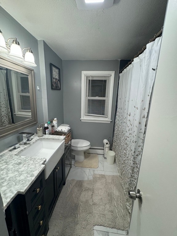 bathroom with a baseboard heating unit, a textured ceiling, walk in shower, vanity, and toilet