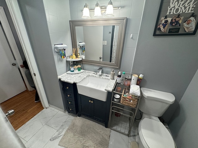 bathroom featuring vanity, hardwood / wood-style floors, and toilet