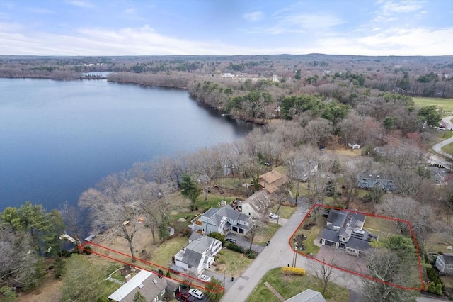 birds eye view of property with a forest view and a water view