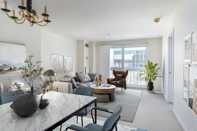 living room with an inviting chandelier and light carpet