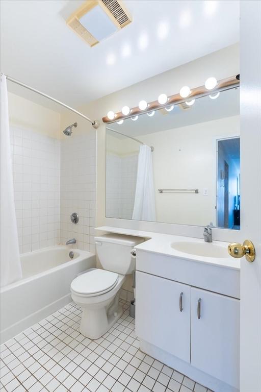 full bathroom with tile patterned flooring, visible vents, vanity, shower / bath combination with curtain, and toilet