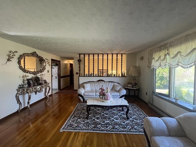 living area with a textured ceiling and wood finished floors