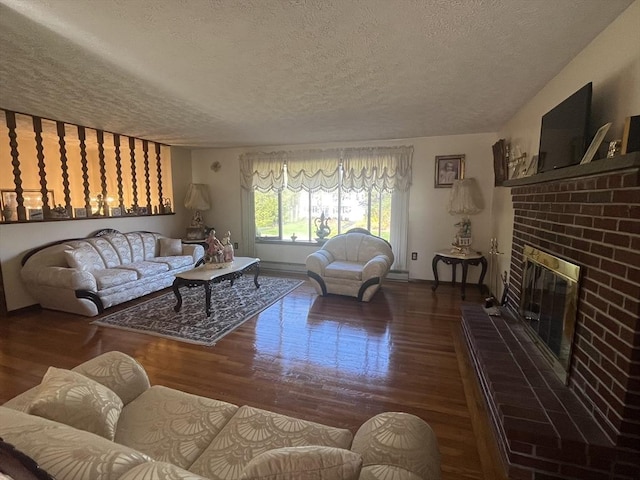 living room with baseboards, a brick fireplace, a textured ceiling, and wood finished floors