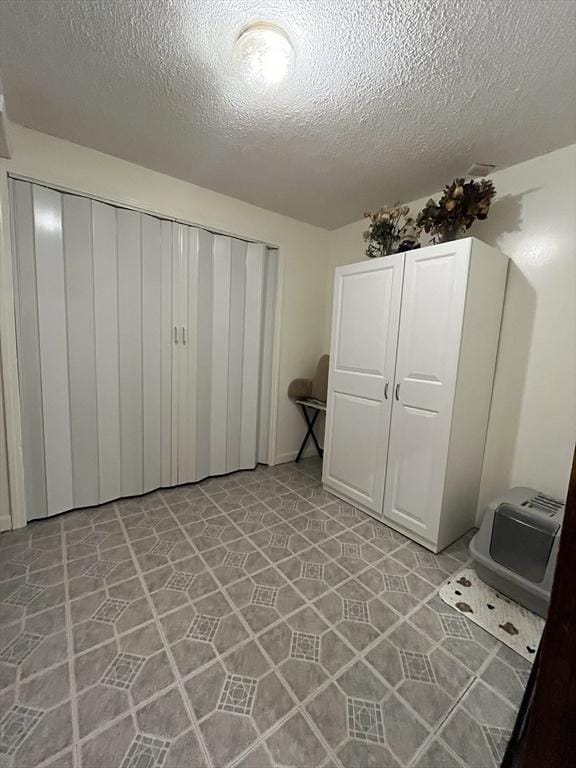 unfurnished bedroom with a closet and a textured ceiling