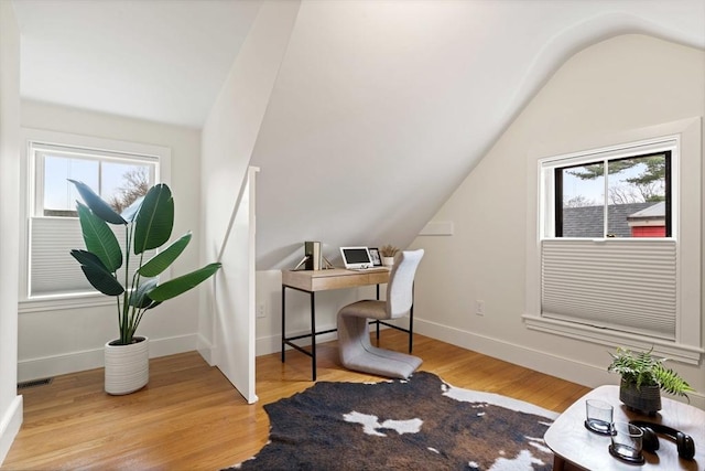 home office with vaulted ceiling, baseboards, and wood finished floors