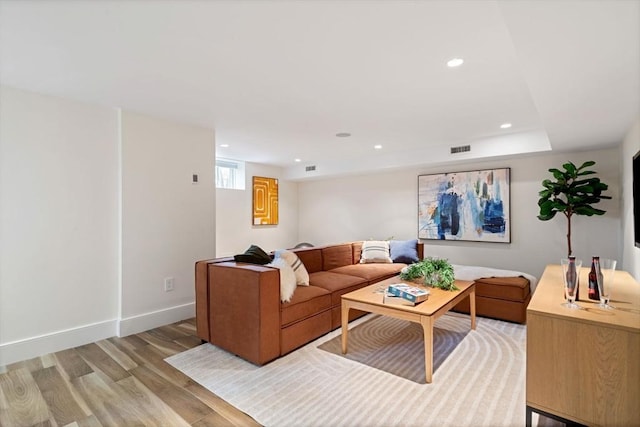 living area with recessed lighting, baseboards, visible vents, and light wood finished floors