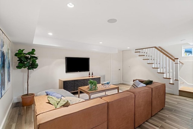 living area with stairs, baseboards, light wood-style flooring, and recessed lighting