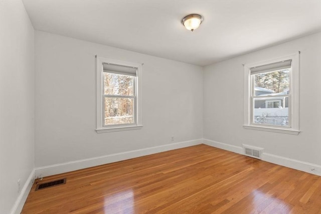 spare room with hardwood / wood-style flooring