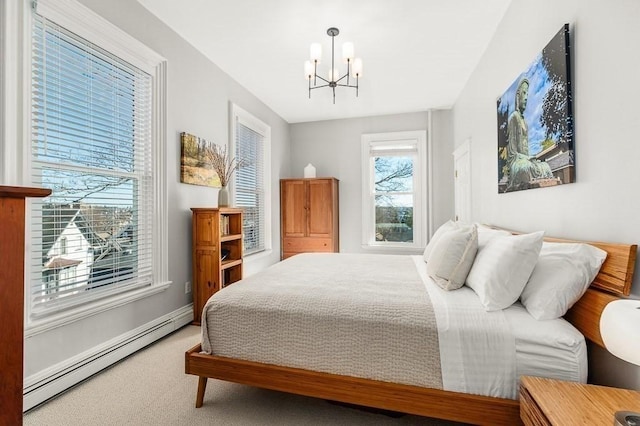 bedroom featuring a baseboard heating unit, a notable chandelier, and carpet flooring