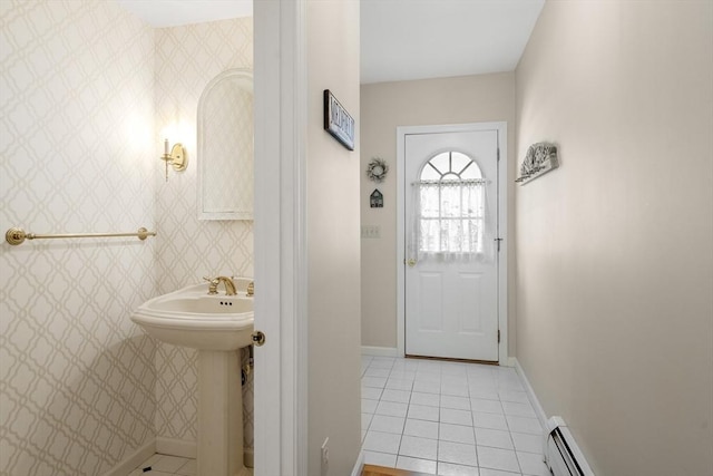 bathroom with tile patterned floors, a sink, wallpapered walls, a baseboard radiator, and baseboards