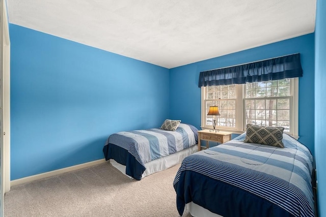 carpeted bedroom featuring baseboards