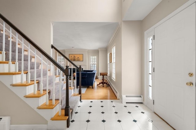 entryway featuring stairs, crown molding, plenty of natural light, and a baseboard radiator