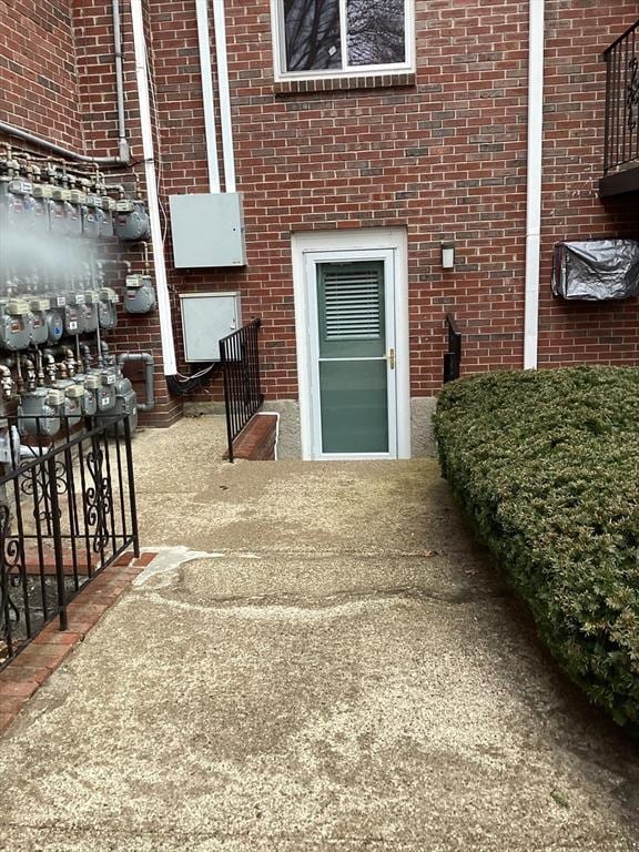 doorway to property with brick siding