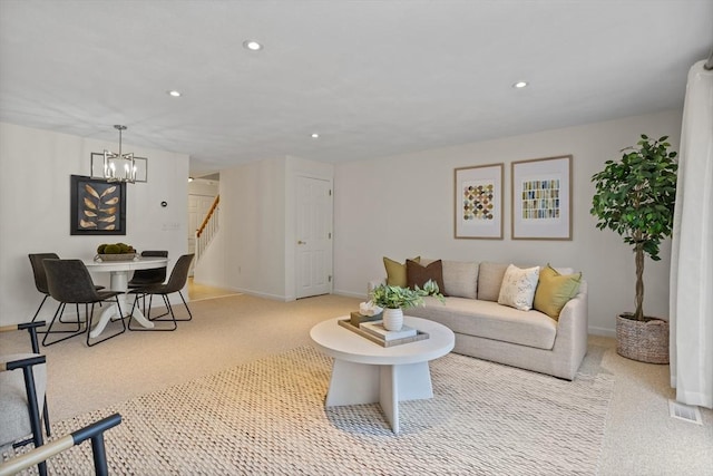 living room featuring stairway, carpet floors, recessed lighting, and a chandelier