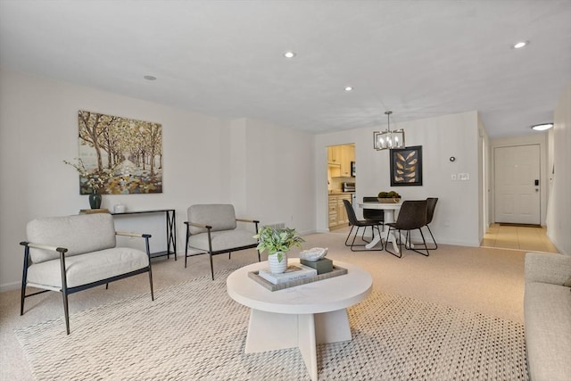 living room with recessed lighting, baseboards, a notable chandelier, and light carpet