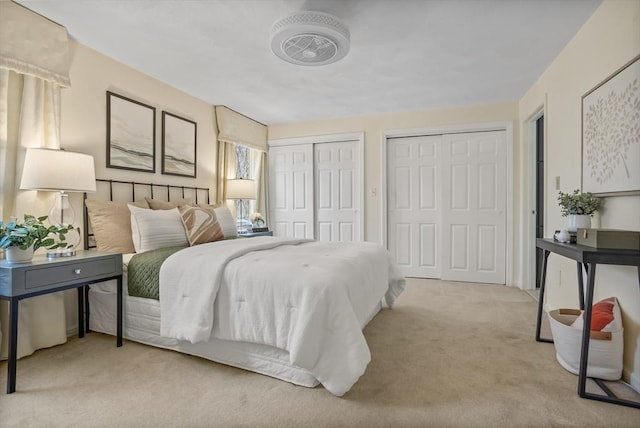 carpeted bedroom with two closets