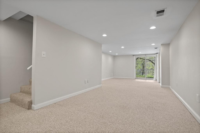spare room featuring recessed lighting, baseboards, visible vents, and light carpet
