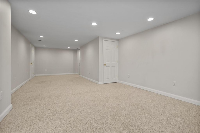 finished basement featuring baseboards, recessed lighting, and light colored carpet