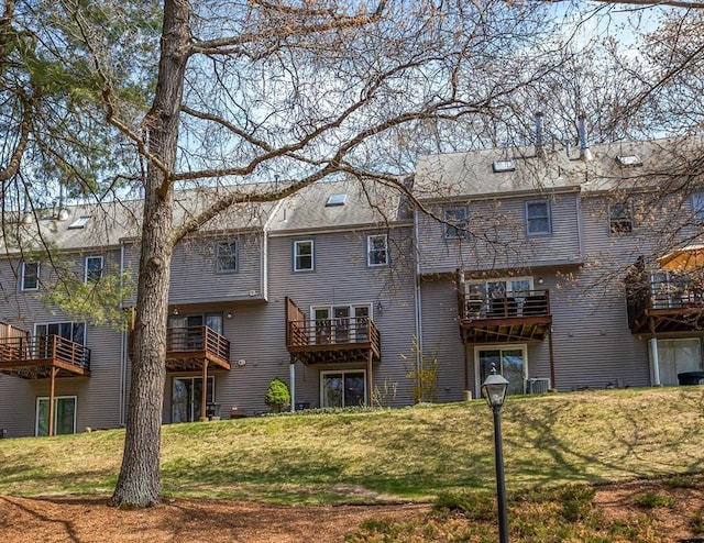 rear view of property with a yard