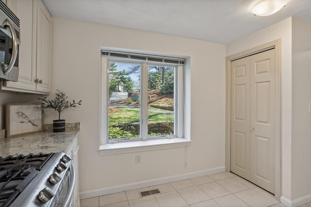 dining area with visible vents, baseboards, and light tile patterned floors
