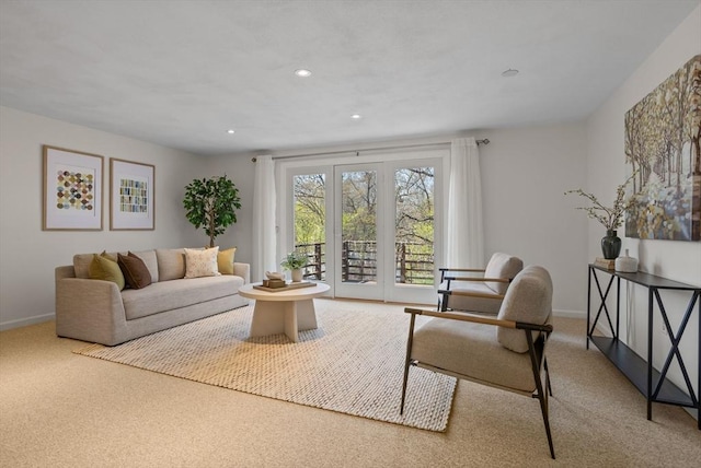 carpeted living area with baseboards and recessed lighting