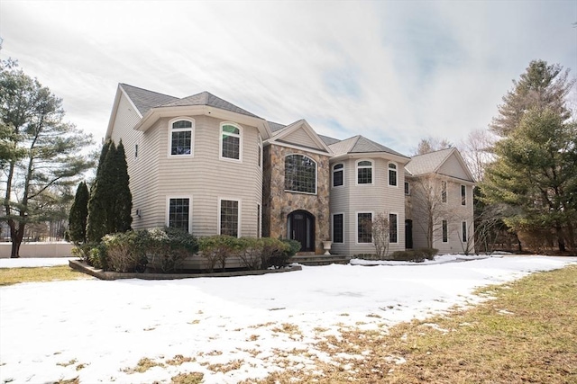 french provincial home featuring stone siding