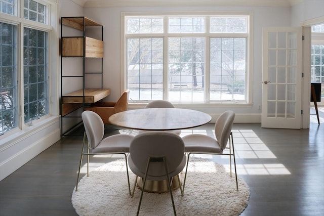 dining room with baseboards and wood finished floors