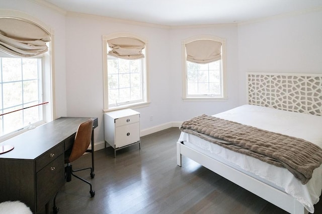 bedroom with ornamental molding, dark wood-type flooring, and baseboards