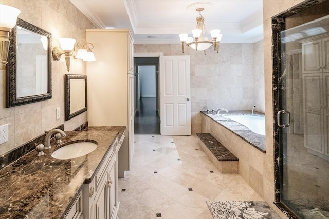 full bathroom featuring a garden tub, ornamental molding, vanity, and tile walls