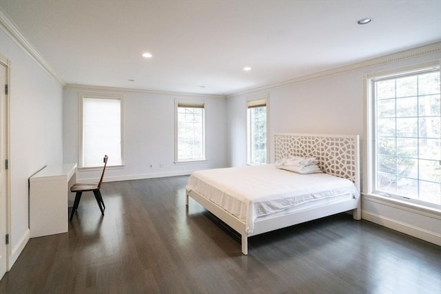 bedroom featuring dark wood finished floors, multiple windows, and crown molding