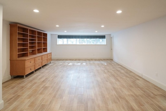 empty room with baseboards, recessed lighting, and light wood-style floors