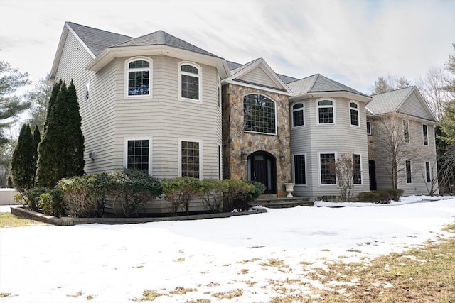 french country home with stone siding