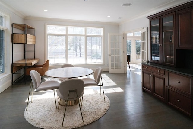 dining area featuring dark wood-style floors, recessed lighting, ornamental molding, and french doors