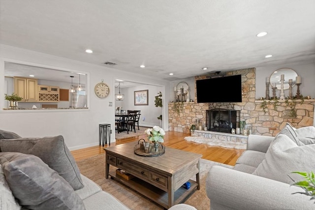9 Indian Rock Dr, Saugus, MA 01906 - living area featuring light wood-style floors, baseboards, crown molding, recessed lighting, and a fireplace