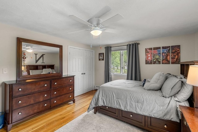 9 Indian Rock Dr, Saugus, MA 01906 - bedroom with light wood finished floors, baseboard heating, a closet, ceiling fan, and a textured ceiling