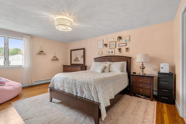 9 Indian Rock Dr, Saugus, MA 01906 - bedroom with a baseboard radiator, wood finished floors, and baseboards