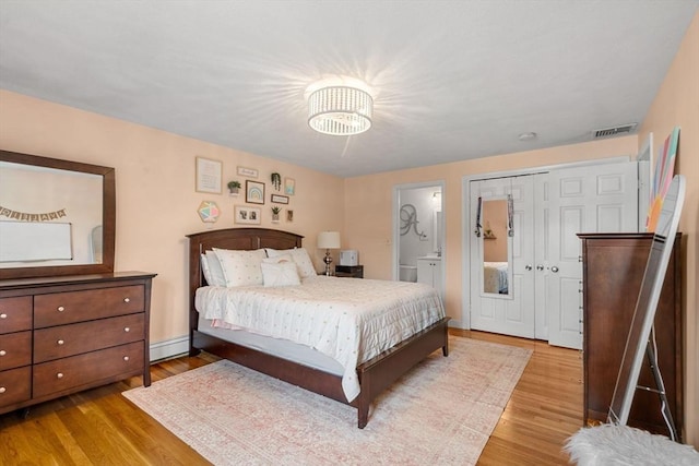 9 Indian Rock Dr, Saugus, MA 01906 - bedroom featuring wood finished floors, baseboard heating, ensuite bathroom, and a chandelier
