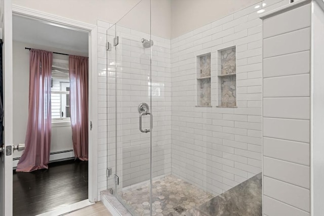 9 Indian Rock Dr, Saugus, MA 01906 - full bathroom featuring a stall shower, wood finished floors, and a baseboard heating unit
