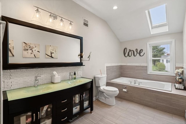 9 Indian Rock Dr, Saugus, MA 01906 - bathroom with a skylight, toilet, lofted ceiling, a bath, and decorative backsplash