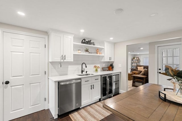 9 Indian Rock Dr, Saugus, MA 01906 - kitchen featuring dishwasher, beverage cooler, a sink, light countertops, and dark wood-style flooring